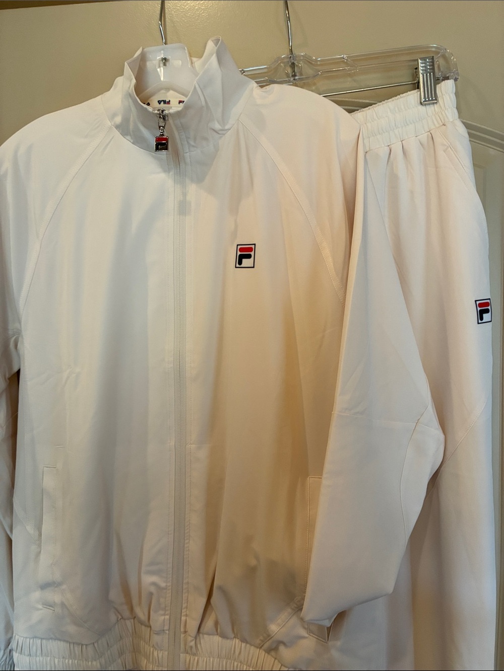 Fila cream Men’s Windbreaker Jacket and pants with Small Logo. Sold as set.